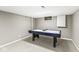 Finished basement area with carpet and includes an air hockey table and storage space at 9221 Holyoke Ct, Indianapolis, IN 46268