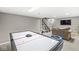 Finished basement area with air hockey table, sofa, television and stairs at 9221 Holyoke Ct, Indianapolis, IN 46268