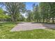 Outdoor community basketball court surrounded by mature trees and grass at 9221 Holyoke Ct, Indianapolis, IN 46268