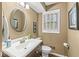 Neutral-toned half-bathroom with a vanity sink and window offering natural light at 9221 Holyoke Ct, Indianapolis, IN 46268