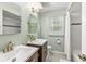 Bathroom featuring double sink vanity, tiled shower, and stylish fixtures at 9221 Holyoke Ct, Indianapolis, IN 46268