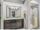 Bathroom featuring granite countertop vanity, large mirror, and glass-door shower at 9221 Holyoke Ct, Indianapolis, IN 46268