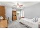 Light-filled bedroom with carpet flooring, closet and a convenient desk with shelving at 9221 Holyoke Ct, Indianapolis, IN 46268