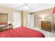Neutral bedroom features plush carpet, a ceiling fan, and dresser with mirror at 9221 Holyoke Ct, Indianapolis, IN 46268