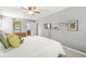 Comfortable bedroom featuring a ceiling fan, ensuite bathroom, and large bed at 9221 Holyoke Ct, Indianapolis, IN 46268
