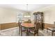 Traditional dining room with decorative china cabinet, round table, and wainscoting at 9221 Holyoke Ct, Indianapolis, IN 46268