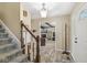 Open foyer with staircase, coat rack, and view into the living room at 9221 Holyoke Ct, Indianapolis, IN 46268
