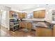 Cozy kitchen with stainless steel appliances, wooden cabinets, and granite countertops at 9221 Holyoke Ct, Indianapolis, IN 46268