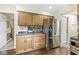 Efficient kitchen area with stainless steel refrigerator and built-in cabinets at 9221 Holyoke Ct, Indianapolis, IN 46268