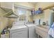 Practical laundry room with a washer, dryer, utility sink, and ample storage at 9221 Holyoke Ct, Indianapolis, IN 46268