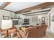 Cozy living room with exposed beam ceilings, fireplace, and lots of light at 9221 Holyoke Ct, Indianapolis, IN 46268
