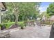 Spacious patio featuring a stone fire pit, ample seating, and beautiful landscaping, ideal for relaxing and entertaining outdoors at 9221 Holyoke Ct, Indianapolis, IN 46268