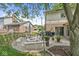 Cozy backyard patio featuring a stone fire pit, seating, and mature trees, perfect for enjoying outdoor gatherings at 9221 Holyoke Ct, Indianapolis, IN 46268
