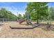 Community playground with a slide, climbing structures, and wood chip ground cover at 9221 Holyoke Ct, Indianapolis, IN 46268