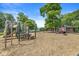 A community playground features a variety of play structures and shade trees at 9221 Holyoke Ct, Indianapolis, IN 46268
