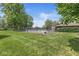 Community pool and lush green space surrounded by mature trees under a bright blue sky at 9221 Holyoke Ct, Indianapolis, IN 46268