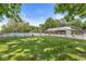 Community pool and clubhouse surrounded by a well maintained lawn and mature trees on a sunny day at 9221 Holyoke Ct, Indianapolis, IN 46268