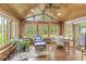 Light-filled sunroom with wood-paneled walls and vaulted ceilings, perfect for relaxation at 9221 Holyoke Ct, Indianapolis, IN 46268