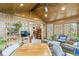 Inviting sunroom with brick accents, wood ceiling, and plenty of natural light for plants at 9221 Holyoke Ct, Indianapolis, IN 46268