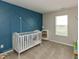 Bright Bedroom with a white crib against an accent wall and natural light from a window at 929 Capricorn Dr, Franklin, IN 46131