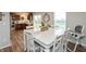 Dining area features a white dining table, natural light and is open to the kitchen at 929 Capricorn Dr, Franklin, IN 46131