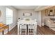 Bright dining area with a white wooden table set, modern decor, and a view of the backyard at 929 Capricorn Dr, Franklin, IN 46131