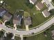 An aerial view showcases homes nestled amongst mature trees and manicured lawns at 9704 Gull Lake Dr, Indianapolis, IN 46239