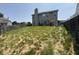 This backyard features a grassy hill down to a privacy fence, with a patio area and a dark metal pergola at 9704 Gull Lake Dr, Indianapolis, IN 46239
