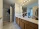 Full bathroom featuring a double vanity, decorative paint, and a separate toilet at 9704 Gull Lake Dr, Indianapolis, IN 46239