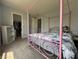 A bedroom featuring a charming pink canopy bed with a peek into the spacious walk-in closet at 9704 Gull Lake Dr, Indianapolis, IN 46239