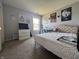 Bright bedroom featuring carpeted floors, a queen bed, and several decorations at 9704 Gull Lake Dr, Indianapolis, IN 46239