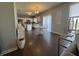 Dining area with a white table, chairs, and views into the kitchen space at 9704 Gull Lake Dr, Indianapolis, IN 46239