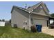 Side view of a home featuring neutral siding, a well-kept lawn, and a two-car garage at 9704 Gull Lake Dr, Indianapolis, IN 46239