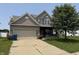 Attractive two-story house showcasing a well-maintained lawn, covered porch, and neutral siding at 9704 Gull Lake Dr, Indianapolis, IN 46239