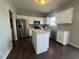 Bright kitchen featuring white cabinets and stainless steel appliances, and an island at 9704 Gull Lake Dr, Indianapolis, IN 46239