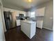 Bright kitchen featuring white cabinets and stainless steel appliances, and a center island at 9704 Gull Lake Dr, Indianapolis, IN 46239