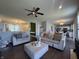 Bright living room with an accent chair, sofa, and ottoman on hardwood floors at 9704 Gull Lake Dr, Indianapolis, IN 46239