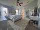 Bright and spacious main bedroom with a ceiling fan, two windows, and white furniture at 9704 Gull Lake Dr, Indianapolis, IN 46239