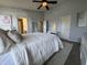 Spacious main bedroom with a ceiling fan, two windows, and white furniture at 9704 Gull Lake Dr, Indianapolis, IN 46239