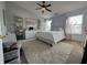 Bright main bedroom featuring a ceiling fan, two windows, a plush rug, and white furniture at 9704 Gull Lake Dr, Indianapolis, IN 46239