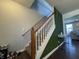 View of carpeted staircase with natural wood handrail and decorative grass wall at 9704 Gull Lake Dr, Indianapolis, IN 46239