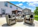 Backyard patio includes a fire pit, seating, and covered area with a grill at 9716 Cimmaron Ave, McCordsville, IN 46055