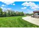 Manicured backyard features a fenced yard, lush green grass, and a beautiful patio with a gazebo and seating at 9716 Cimmaron Ave, McCordsville, IN 46055