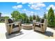 Backyard patio featuring swivel chairs around a stone fire pit for outdoor enjoyment at 9716 Cimmaron Ave, McCordsville, IN 46055