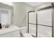 Well-lit bathroom includes a sink vanity, toilet, and a fully enclosed shower with glass sliding doors at 9716 Cimmaron Ave, McCordsville, IN 46055