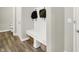Mudroom with bench, storage hooks and baskets, and adjacent access to a half bathroom at 9716 Cimmaron Ave, McCordsville, IN 46055