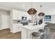 Modern kitchen features a central island, pendant lighting, stainless steel appliances, and stylish countertops at 9716 Cimmaron Ave, McCordsville, IN 46055