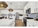 Spacious kitchen with stainless steel appliances, a large island, white cabinets, and contemporary pendant lighting at 9716 Cimmaron Ave, McCordsville, IN 46055