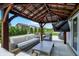 Inviting outdoor space with covered patio, TV, and comfortable seating area for relaxing and entertaining at 9716 Cimmaron Ave, McCordsville, IN 46055