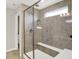 Beautiful walk-in shower featuring modern tile, a bench seat, and glass surround at 9716 Cimmaron Ave, McCordsville, IN 46055